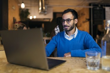 Businessman using laptop in cafe