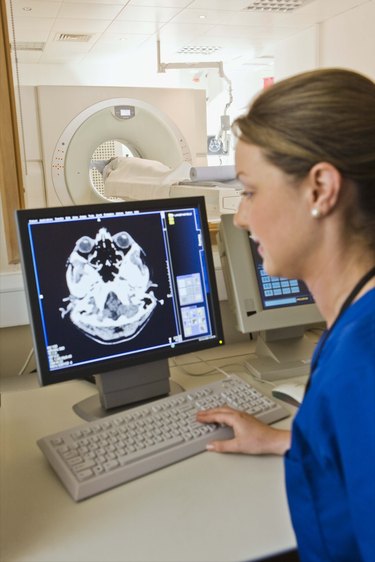 Technician doing CAT scan in hospital