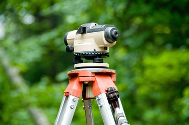 Close-up of theodolite atop tripod