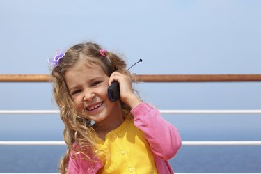Little girl stands and talks by portable radio