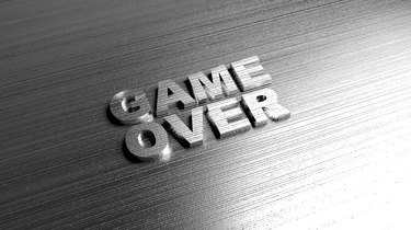 Metal words 'Game over' on metal surface