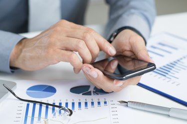 Close-up Of Businessman Using Cell Phone