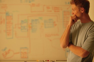 Man analyzes workflow chart
