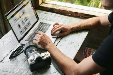 Male on laptop in beach hut